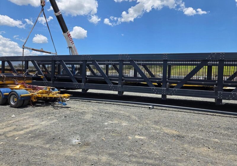 Bridge truss under crane, ready to load