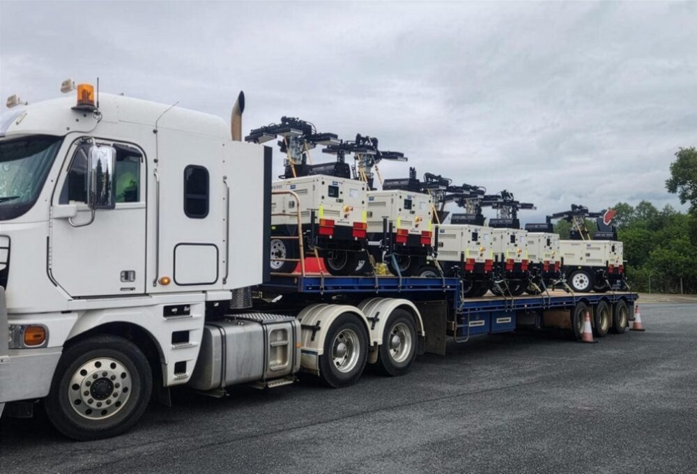 Drop deck trailer loaded with machinery
