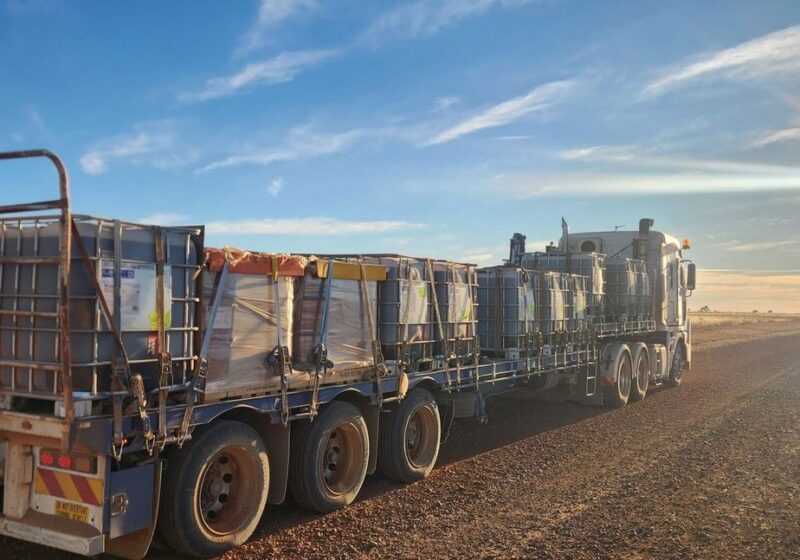 Road train heading west at sunset